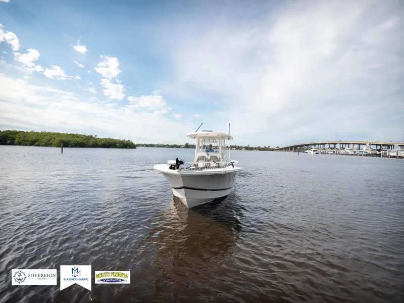 Slide: The Image of 2024 Regulator 30XO boat on calm water under a clear sky. - 8