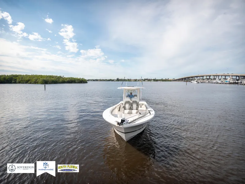 Slide: The Image of 2024 Regulator 30XO boat on calm water under a clear sky. - 9