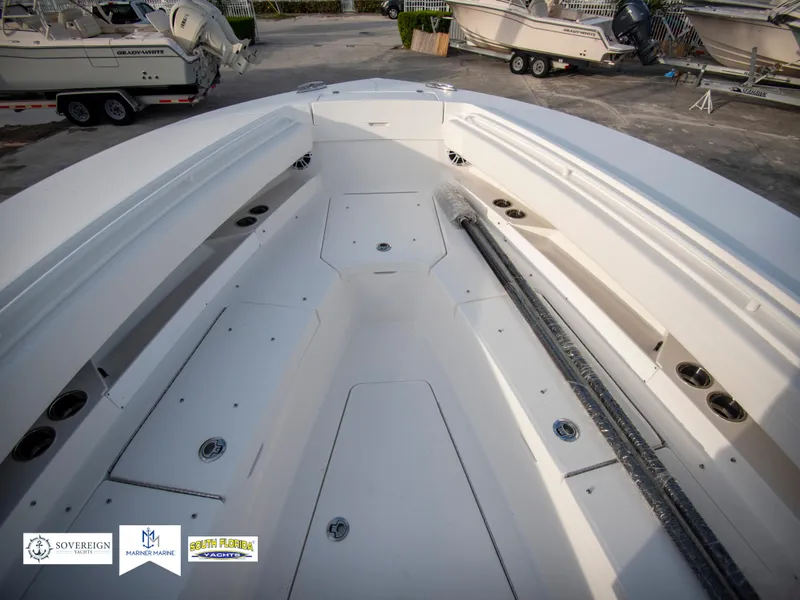 Slide: The Image of 2024 Regulator 31 boat deck with storage compartments and seating. - 17