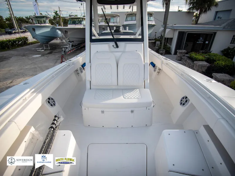 Slide: The Image of 2024 Regulator 31 boat interior with white seating and storage compartments. - 18