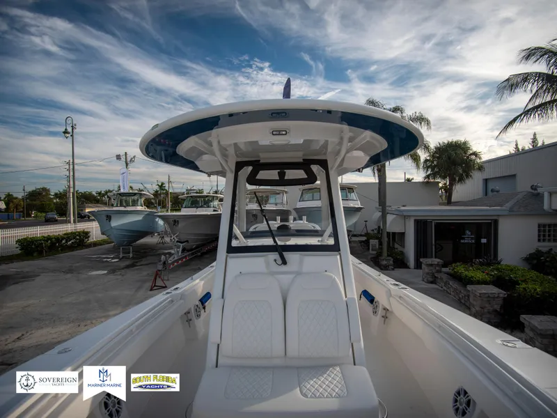 Slide: The Image of 2024 Regulator 31 boat at a marina under a partly cloudy sky. - 19