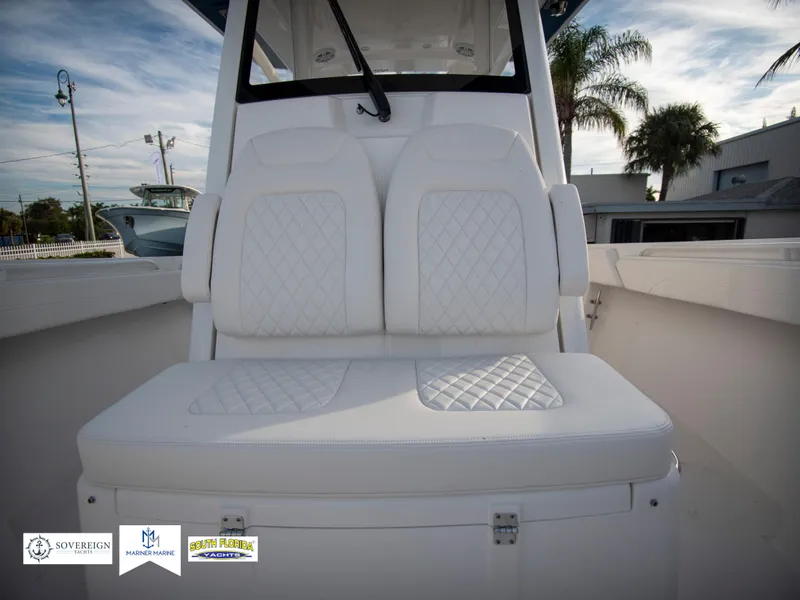 Slide: The Image of 2024 Regulator 31 boat with white cushioned seating and diamond stitching. - 20