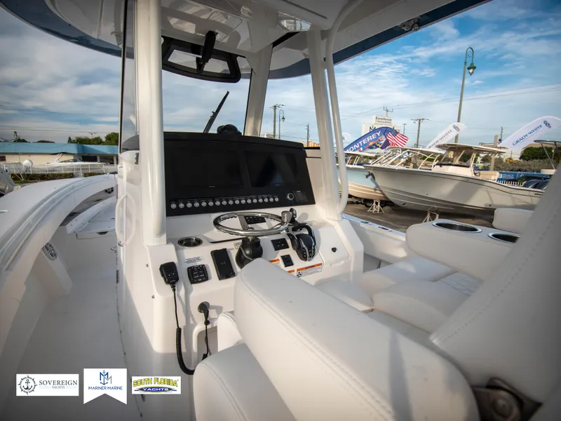 Slide: The Image of 2024 Regulator 31 boat cockpit with advanced navigation system and white seating. - 23