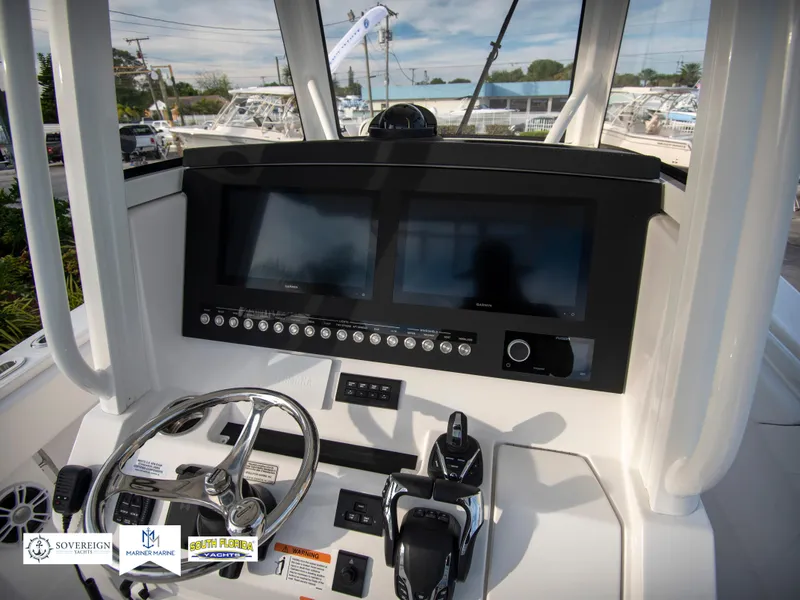 Slide: The Image of 2024 Regulator 31 boat dashboard with dual screens and control panel. - 24