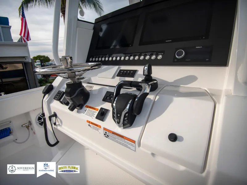 Slide: The Image of Control panel of 2024 Regulator 31 boat with dual throttle levers and display screens. - 25