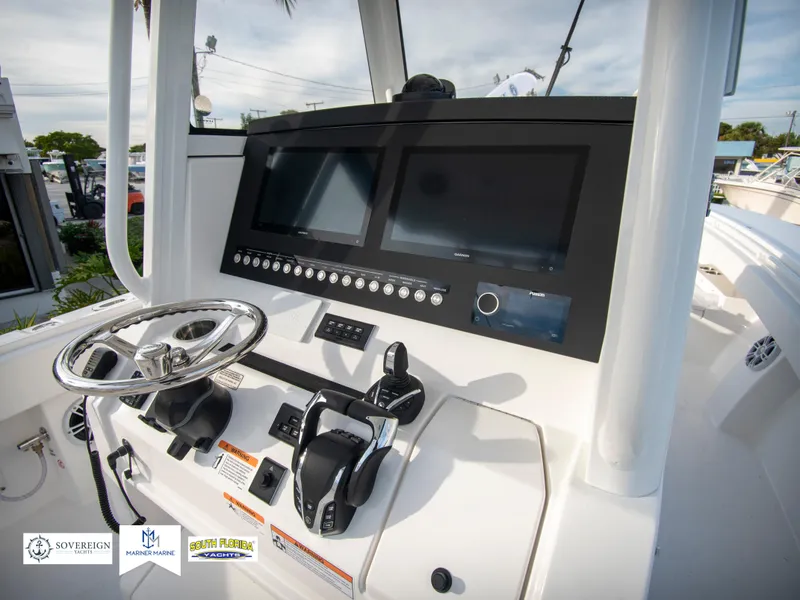 Slide: The Image of 2024 Regulator 31 boat dashboard with dual screens and steering wheel. - 26