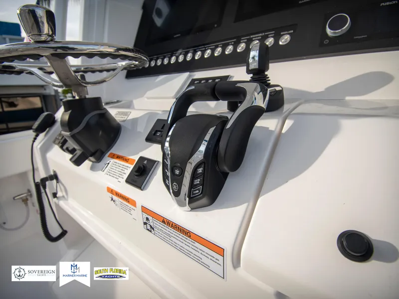 Slide: The Image of 2024 Regulator 31 boat control panel with steering wheel and throttle. - 27