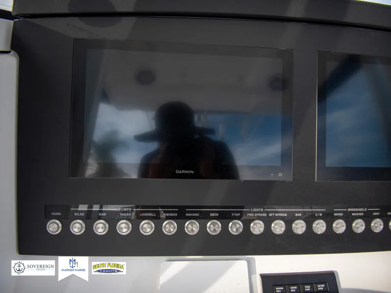 Slide: The Image of Control panel of a 2024 Regulator 31 boat with Garmin display screens. - 28