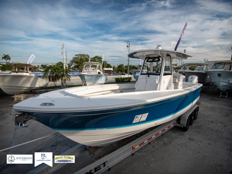 Slide: The Image of 2024 Regulator 31 boat on trailer, displayed at a marina. - 3
