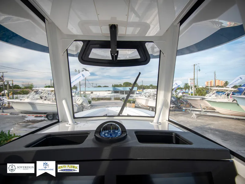 Slide: The Image of View from the helm of a 2024 Regulator 31 boat at a marina. - 30