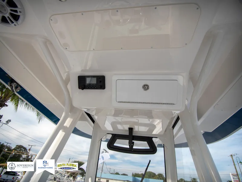 Slide: The Image of 2024 Regulator 31 boat interior ceiling with storage compartment and electronic display. - 31
