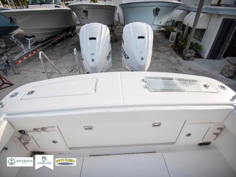 Slide: The Image of 2024 Regulator 31 boat with twin outboard engines at a marina. - 36