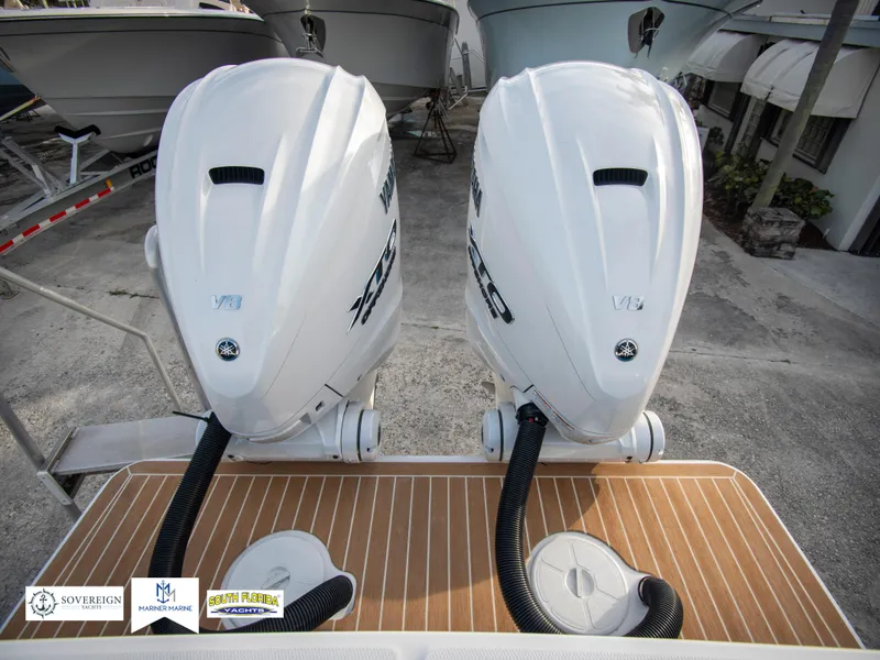Slide: The Image of 2024 Regulator 31 boat with twin outboard engines. - 37