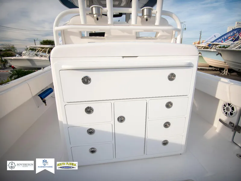 Slide: The Image of 2024 Regulator 31 boat with white storage drawers in the cockpit. - 39