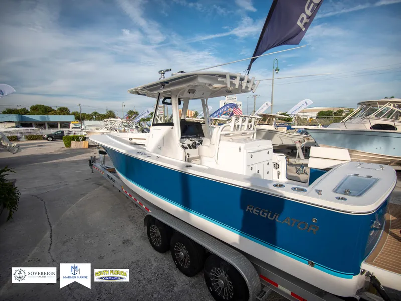 Slide: The Image of 2024 Regulator 31 boat on a trailer, displayed outdoors. - 4