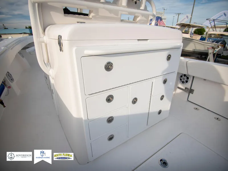 Slide: The Image of 2024 Regulator 31 boat storage compartments and seating area. - 40