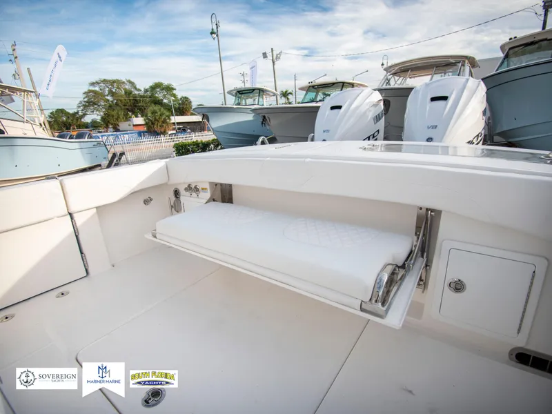 Slide: The Image of 2024 Regulator 31 boat with foldable seating and twin outboard engines. - 42