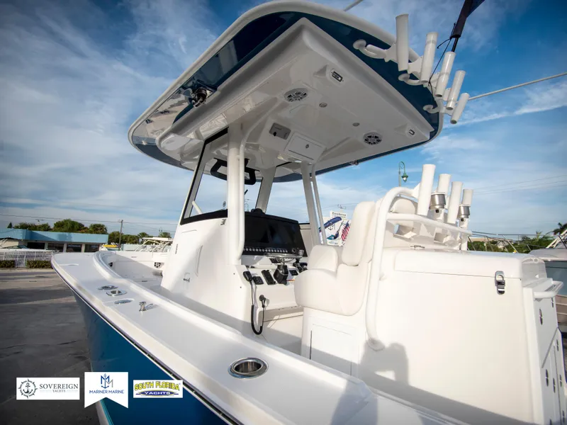 Slide: The Image of 2024 Regulator 31 boat with center console and fishing rod holders. - 6