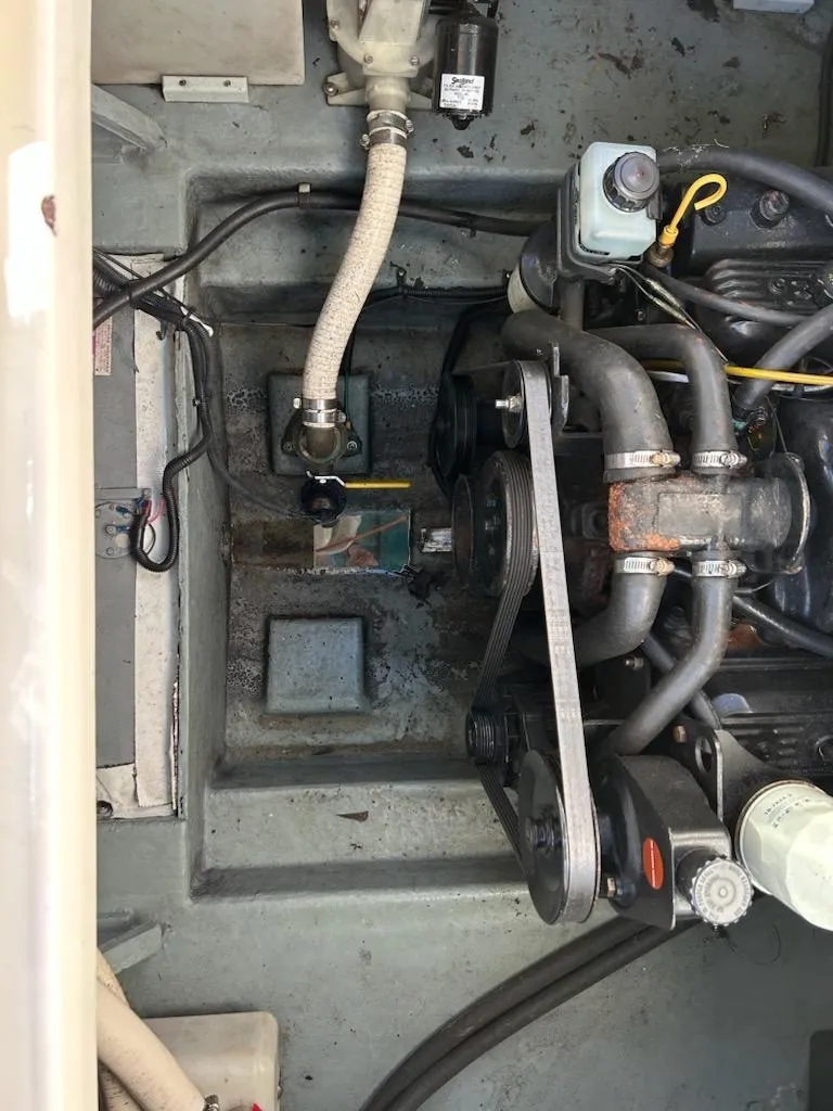 Slide: The Image of 1997 Sea Ray Sundancer engine compartment with visible hoses and belts. - 11