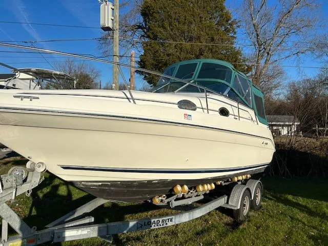 Slide: The Image of 1997 Sea Ray Sundancer boat on trailer with green canopy. - 14