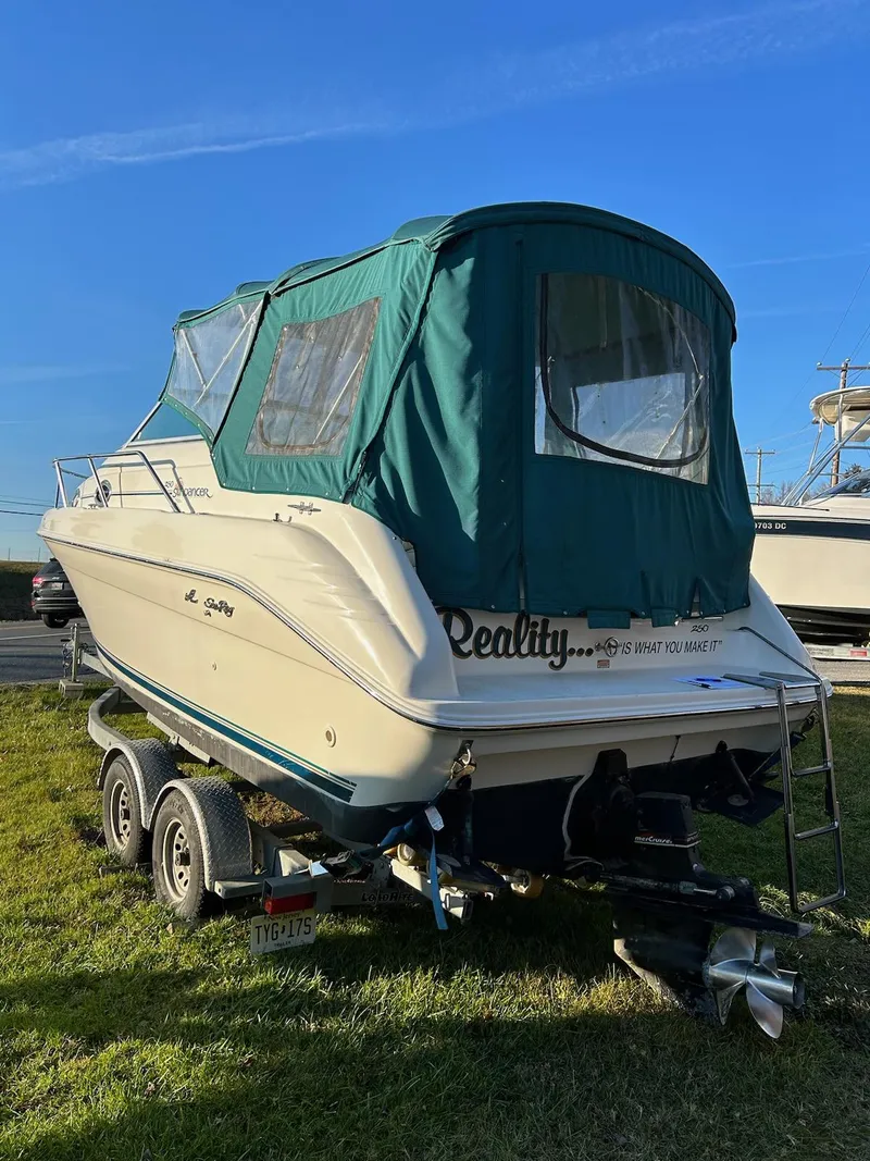 Slide: The Image of 1997 Sea Ray Sundancer boat on trailer with green canopy. - 16