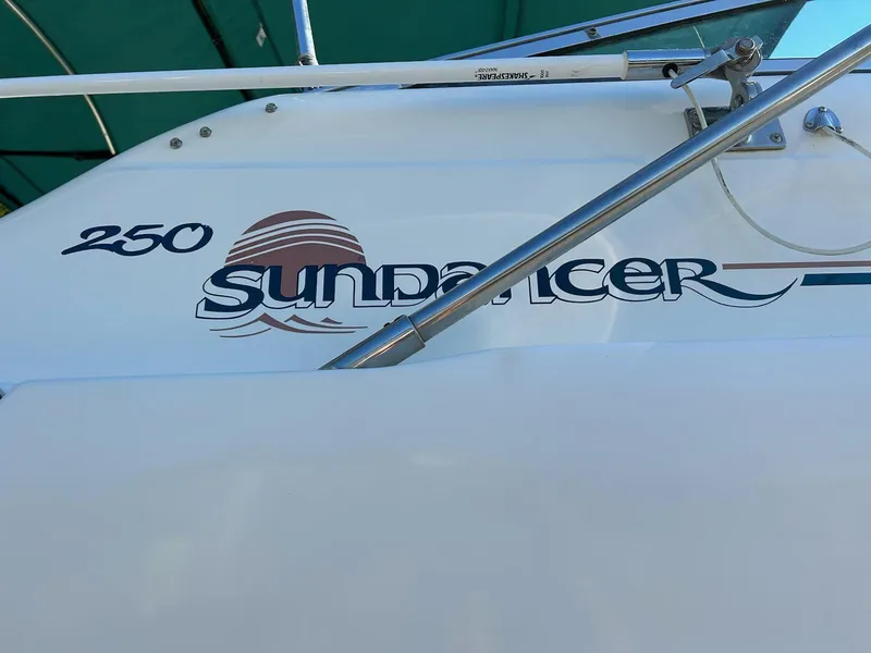 Slide: The Image of 1997 Sea Ray Sundancer 250 boat model name and logo. - 3