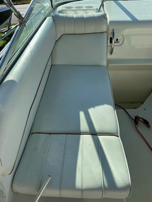 Slide: The Image of 1997 Sea Ray Sundancer white cushioned seating area. - 4