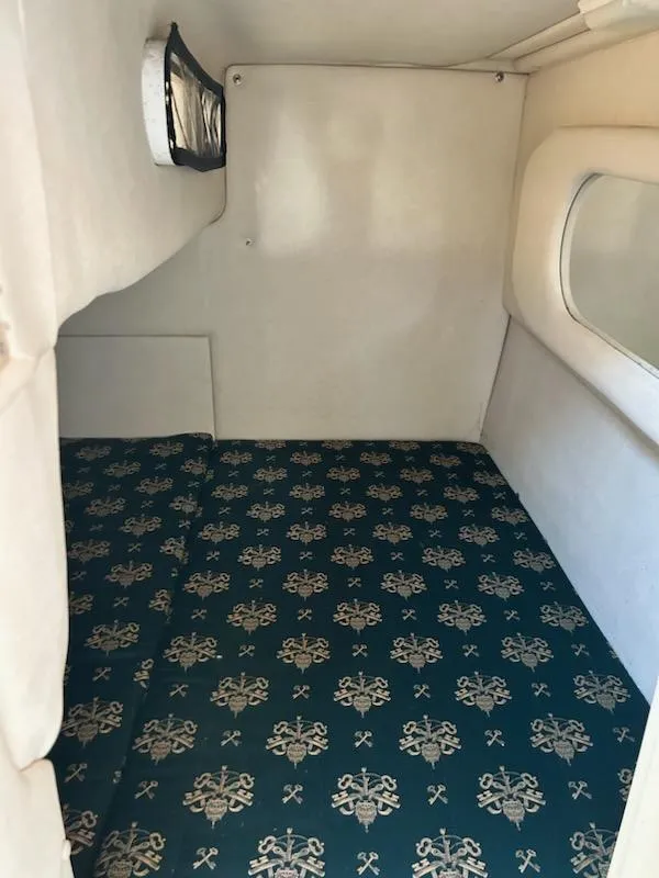 Slide: The Image of 1997 Sea Ray Sundancer cabin interior with patterned bedding. - 7