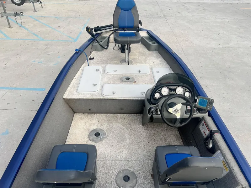 Slide: The Image of 2013 Tracker Pro Team 175 TF fishing boat interior with steering console and seating. - 4