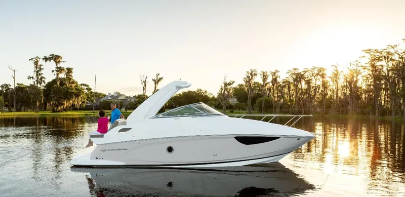 Slide: The Image of 2024 Regal 28 Express boat on a serene lake at sunset. - 2