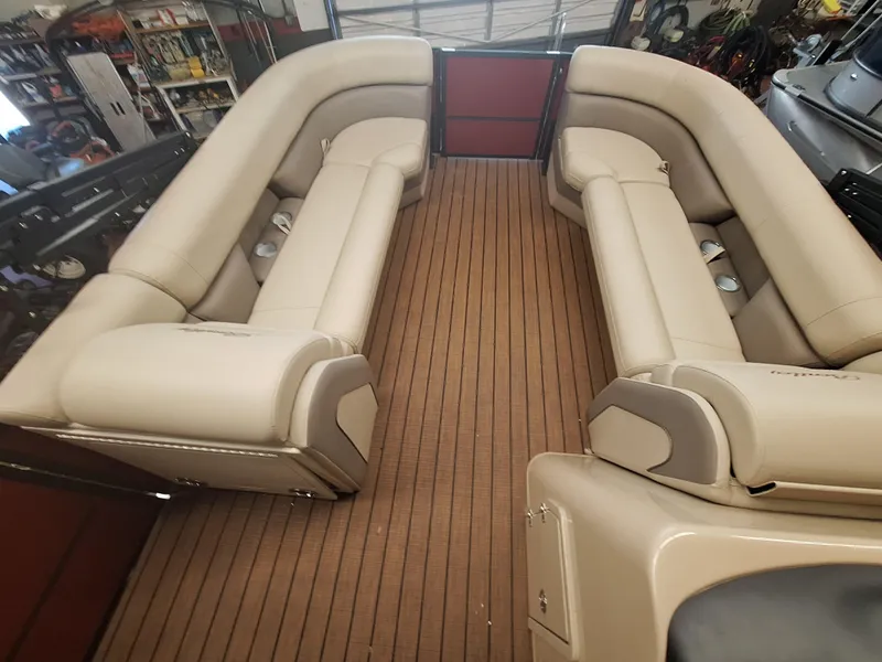 Slide: The Image of 2024 Bentley Pontoons Elite 253 SwingBack DC interior with luxurious seating and wood flooring. - 10