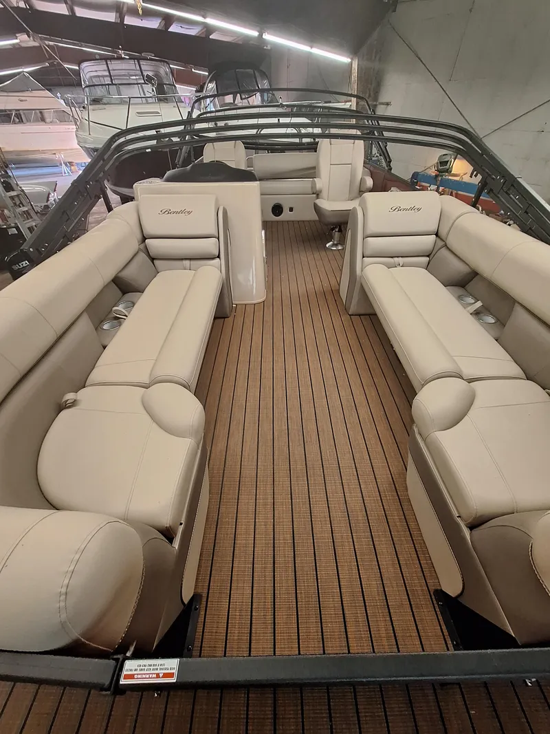 Slide: The Image of 2024 Bentley Pontoons Elite 253 SwingBack DC interior with luxurious seating. - 11