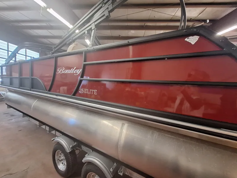 Slide: The Image of 2024 Bentley Pontoons Elite 253 SwingBack DC in a showroom. - 3