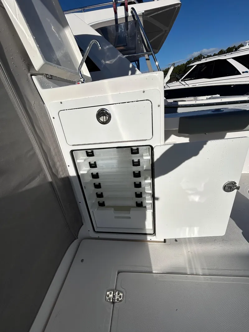 Slide: The Image of 2024 NorthCoast 315HT boat interior with storage compartments and sleek design. - 10