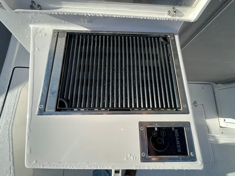 Slide: The Image of Built-in grill on 2024 NorthCoast 315HT boat, featuring Kenyon control panel. - 11