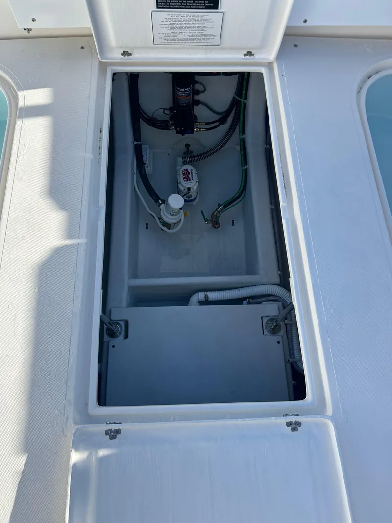 Slide: The Image of 2024 NorthCoast 315HT boat compartment with visible wiring and components. - 12