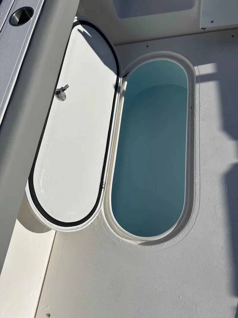 Slide: The Image of 2024 NorthCoast 315HT boat storage compartment with open hatch, showing interior details. - 13