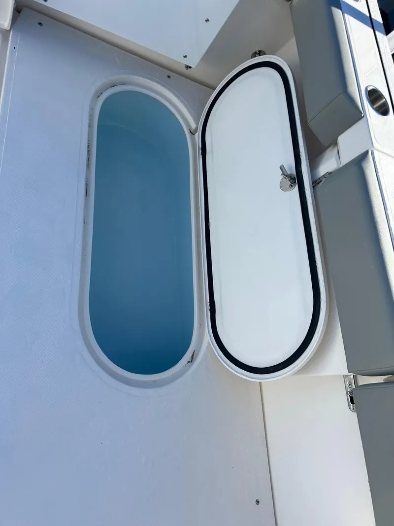 Slide: The Image of 2024 NorthCoast 315HT boat storage compartment with open hatch. - 14