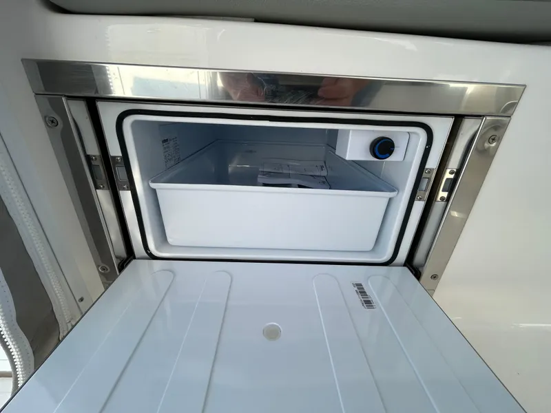 Slide: The Image of Open storage compartment in 2024 NorthCoast 315HT boat, featuring a sleek design. - 19