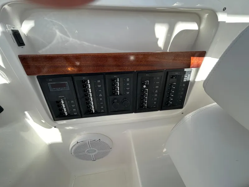Slide: The Image of 2024 NorthCoast 315HT boat control panel with switches and speaker. - 20