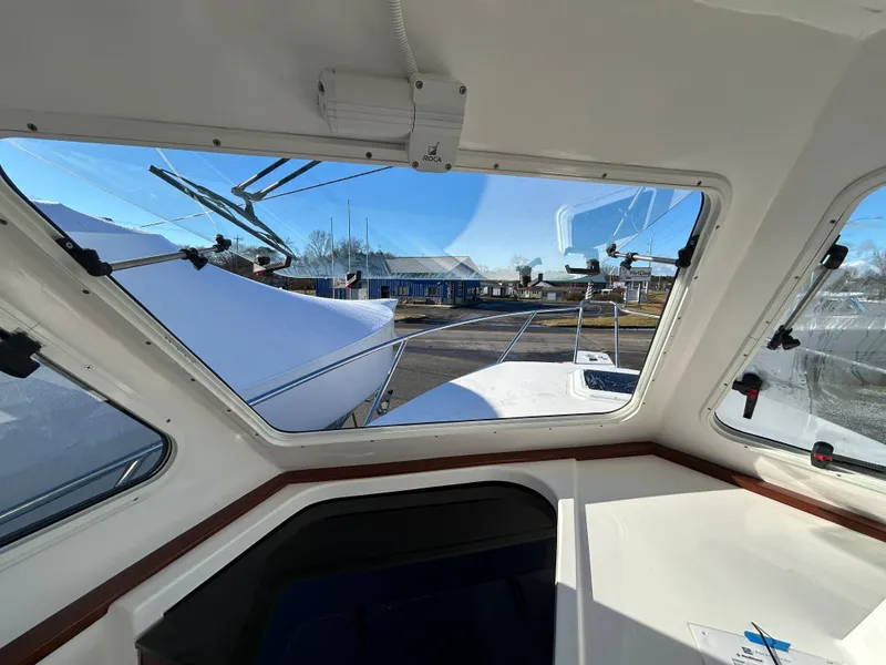 Slide: The Image of Interior view of 2024 NorthCoast 315HT boat, showcasing windshield and dashboard. - 24