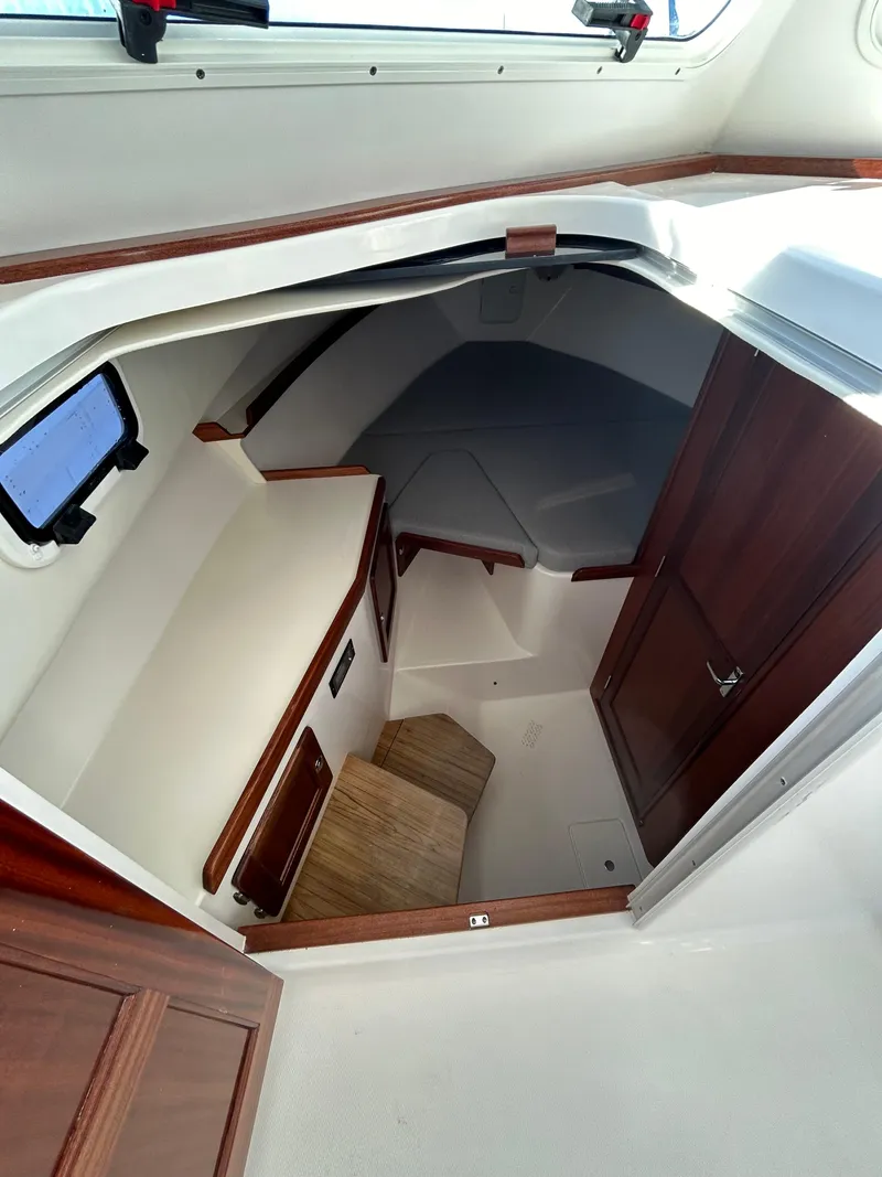 Slide: The Image of 2024 NorthCoast 315HT cabin interior with wooden accents and compact design. - 25