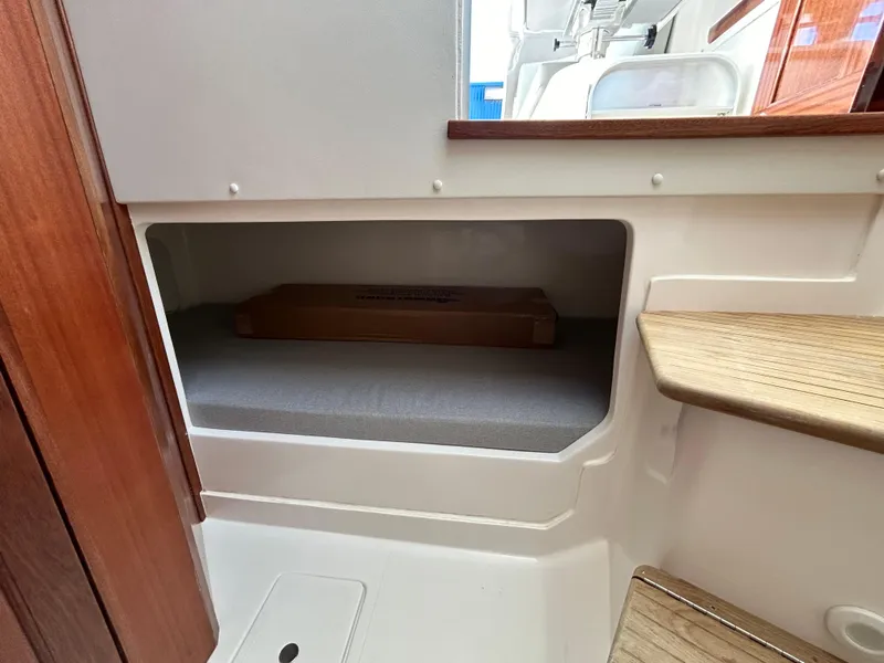 Slide: The Image of 2024 NorthCoast 315HT boat interior storage compartment with wooden steps. - 29