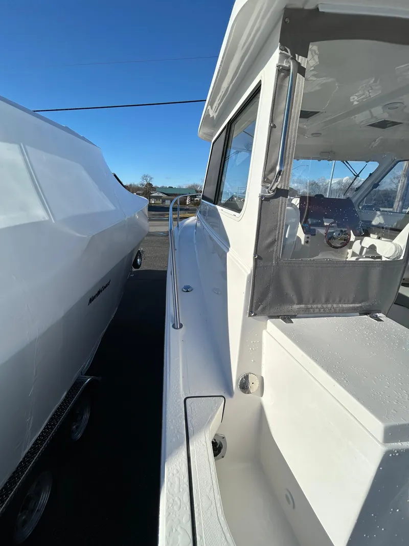 Slide: The Image of 2024 NorthCoast 315HT boat side view, showcasing sleek design and modern features. - 30