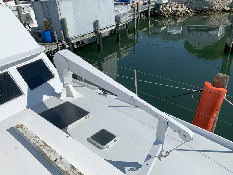 Slide: The Image of 1986 Gladding Hearn Hunt Designed 60 boat docked at a marina. - 10