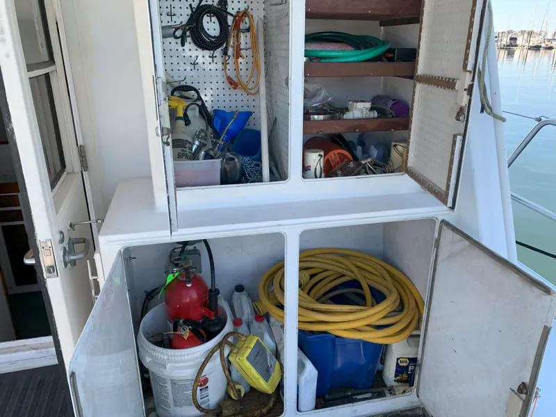 Slide: The Image of Storage compartments on a 1986 Gladding Hearn Hunt Designed 60 boat, filled with tools and equipment. - 14