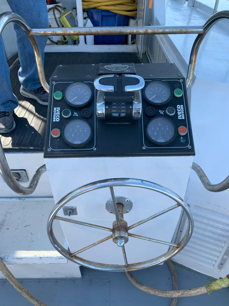 Slide: The Image of Control panel and steering wheel of a 1986 Gladding Hearn Hunt Designed 60 boat. - 16