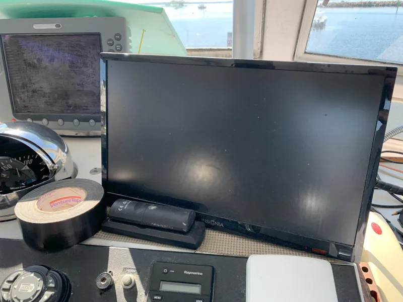 Slide: The Image of Boat control panel with monitor and navigation equipment on a 1986 Gladding Hearn Hunt Designed 60. - 33