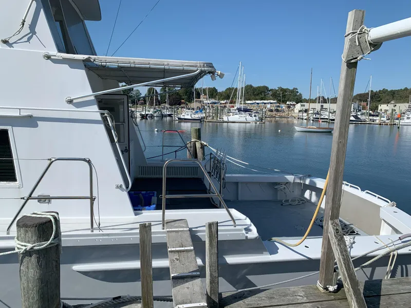 Slide: The Image of 1986 Gladding Hearn Hunt Designed 60 docked at a marina with boats in the background. - 4