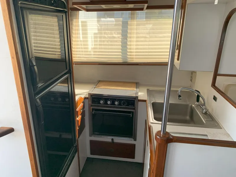 Slide: The Image of Compact kitchen area in a 1986 Gladding Hearn Hunt Designed 60 boat. - 41